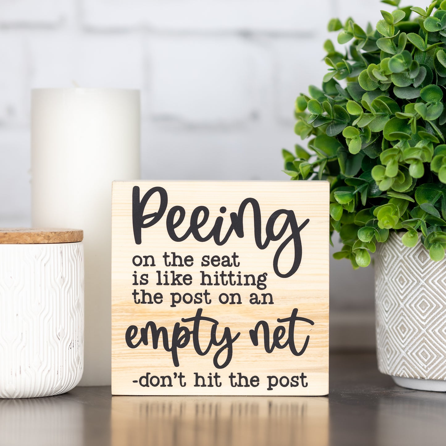peeing on the seat is like hitting the post on an empty net ~ block sign